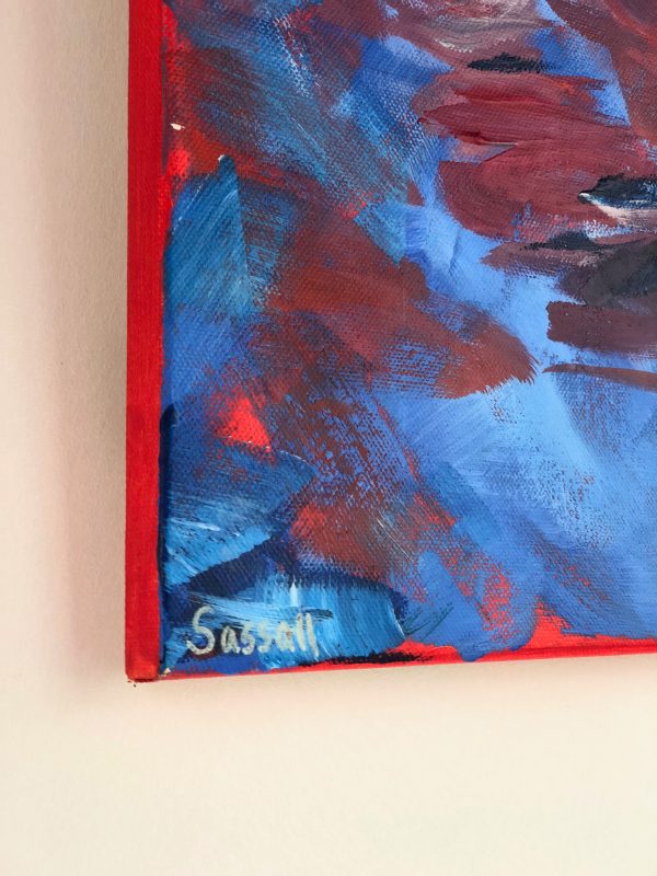 photo of the edge of a painted canvas of a swing chair showing red edge